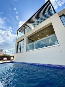 a house with a swimming pool in front of a house at Βίλα -Θαλασσινή αύρα, 500μέτρα από την θάλασσα in Áyios Andónios