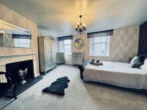 a bedroom with a large bed and a fireplace at Riverside House, North Shields Fish Quay in South Shields