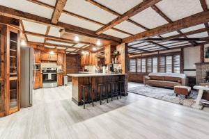 a large kitchen with wooden ceilings and an open floor plan at Luxury-Cabin Mount View *Gym*Game Room *Fire Place in Lehighton