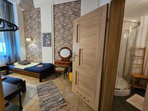 a room with a bathroom with a shower and a mirror at Deja Vu Hostel in Warsaw