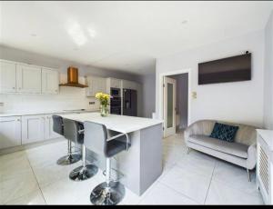 a kitchen and living room with a table and chairs at Deluxe Dwelling - 15 mins from Cork City/Airport in Cork