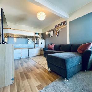 a living room with a couch and a bed at Familiebolig med nydelig utsikt in Trondheim