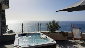 a bath tub with a view of the ocean at Castelo do Mar, Madeira in Tábua