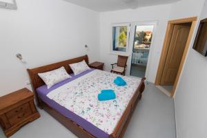 a bedroom with a bed with a blue tray on it at Vila Niko Dalmacija in Sukošan