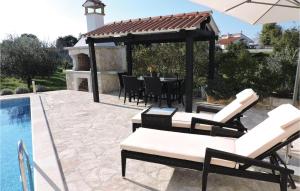 a patio with a table and chairs next to a pool at Holiday Home Barban 60 in Barban +35 photos