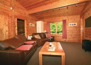 a living room with a couch and a table at Spindlewood Lodges in North Wootton