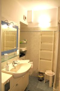 a bathroom with a sink and a mirror at Pae veciu camera privata con bagno in Monterosso al Mare