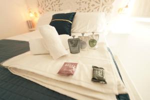a hotel room with a bed with towels and bottles on it at Mazzarò Luxury Apartment Taormina in Taormina