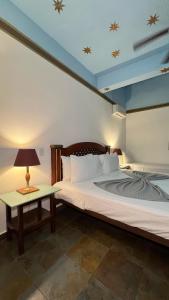 a bedroom with a large bed and a table at Hotel San Marco  in Santo Domingo