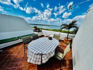 a table and chairs on a balcony with a view of the ocean at Solymar condos on the beach in Cancún