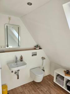 a bathroom with a toilet and a sink at Apartment Home 3 in Schwabach