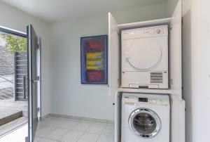 uma máquina de lavar e secar roupa numa lavandaria branca em Appartement Waldheim em Bad Nauheim