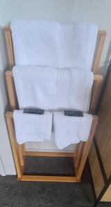 a towel rack with white towels on it at Bonnie Doone in Te Awamutu