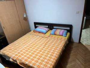 un letto con due cuscini sopra in una stanza di Apartmani Vlaška a Vlaška