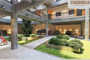 a building with cars parked in a parking lot at Depto en Buenos Aires, Ciudadela. in Ciudadela