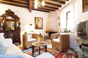 a living room with a couch and chairs and a tv at Historical House in the Old City of Nicosia in Nicosia