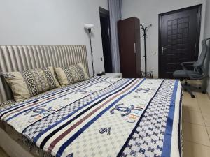 a bed with a quilt on it in a bedroom at ocean view Dubai Marina JBR walk comfort room in Dubai