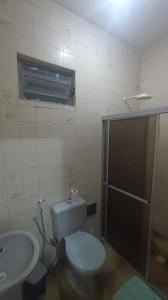 a bathroom with a toilet and a sink at Kitnet em Aracaju para 3 pessoas in Aracaju