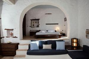 a bedroom with a bed and a couch in a room at Historical Stone Manor-Upper floor in Hydra