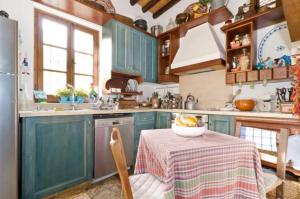 a kitchen with a table with a bowl of fruit on it at Historical House in the Old City of Nicosia in Nicosia +12 photos