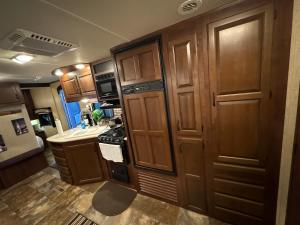 a kitchen with wooden cabinets and a stove at The paradise in Lehigh Acres