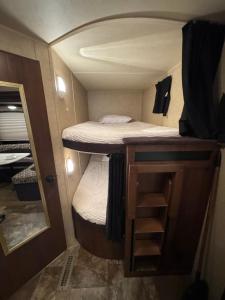 a small room with a bunk bed in a trailer at The paradise in Lehigh Acres
