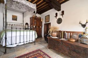 a bedroom with a bed and a wooden dresser at Historical House in the Old City of Nicosia in Nicosia