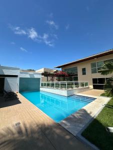 a swimming pool in front of a building at Pousada Olho D'água in São Luís