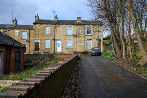 a large brick house with a car parked in front of it at Home in West Yorkshire, Close to Leeds City Center, Sleeps 3! in Batley