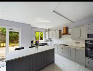a kitchen with white cabinets and a white counter top at Deluxe Dwelling - 15 mins from Cork City/Airport in Cork