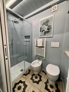 a bathroom with a toilet and a glass shower at La Torre di Canonica in Colle di Val d'Elsa