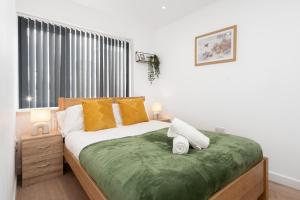 a bedroom with a large bed and a window at Dazzling & Modern 4bd - Nr Etihad - Parking -EV in Manchester