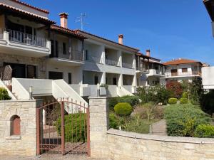 a row of apartment buildings with a gate at "Ariane" - Afytos village with sea view in Afitos