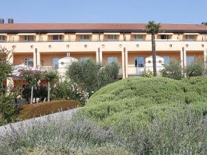 a building with a garden in front of it at Hotel Caesius Thermae & Spa Resort in Bardolino