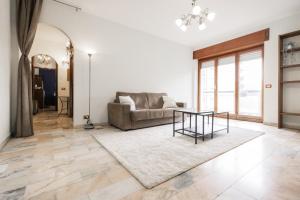a living room with a couch and a table at Big Deluxe apts Italian Style Lake&Terrace in Lecco