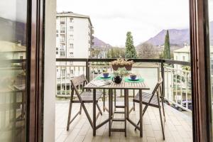 a table and chairs on a balcony with a view at Big Deluxe apts Italian Style Lake&Terrace in Lecco