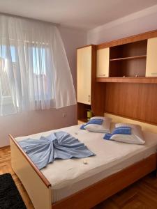 a bed with two pillows on it in a bedroom at Apartment Agata in Trogir