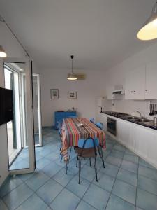 a kitchen with a table and chairs in a room at Arcadia Case e Vacanze in Ischia