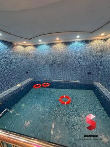 a swimming pool with a pair of scissors in it at منتجع سمو الوسام Wesam Highness Resort in Taif