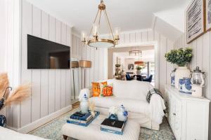 a living room with a white couch and a tv at Gorgeous House in Sidcup in Streatham Hill