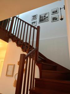a staircase in a house with pictures on the wall at As Conchas in Vilagarcia de Arousa