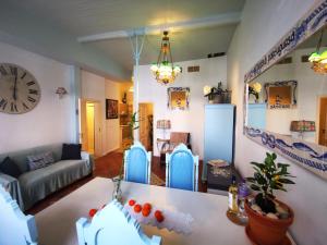 a living room with a clock on the wall at Charming Portuguese style apartment, for rent "Vida à Portuguesa", "Sardinha" Alojamento Local in Portimão