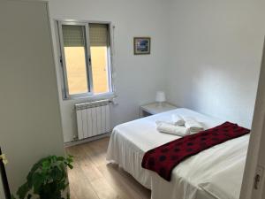 sypialnia z łóżkiem z dwoma ręcznikami w obiekcie AR2 Luminoso piso de 3 habs con balcón y WIFI w Madrycie