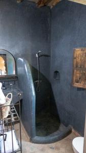 a bathroom with a shower in a blue wall at JNANE ZOHRA in Taroudant