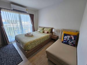 a small bedroom with a bed and a window at Rose 'Lacasita Huahin in Hua Hin