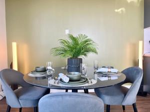 a dining room table with chairs and a plant on it at Hollywood Sign View 2 Bed 2 Bath Premium Corner in Los Angeles
