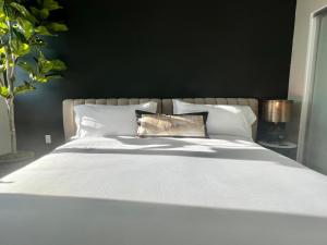 a white bed with a pillow on top of it at Hollywood Sign View 2 Bed 2 Bath Premium Corner in Los Angeles +16 photos