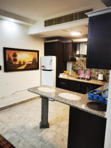 a kitchen with a counter and a refrigerator at 2 bedrooms apartment no 18 in Amman