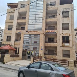 a car parked in front of a building at 2 bedrooms apartment no 18 in Amman