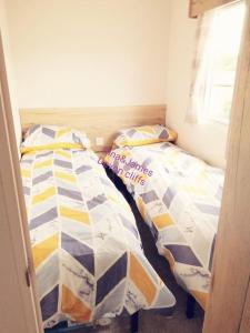 A bed or beds in a room at 3 Bedroom Deluxe Caravan at Haven Devon Cliffs